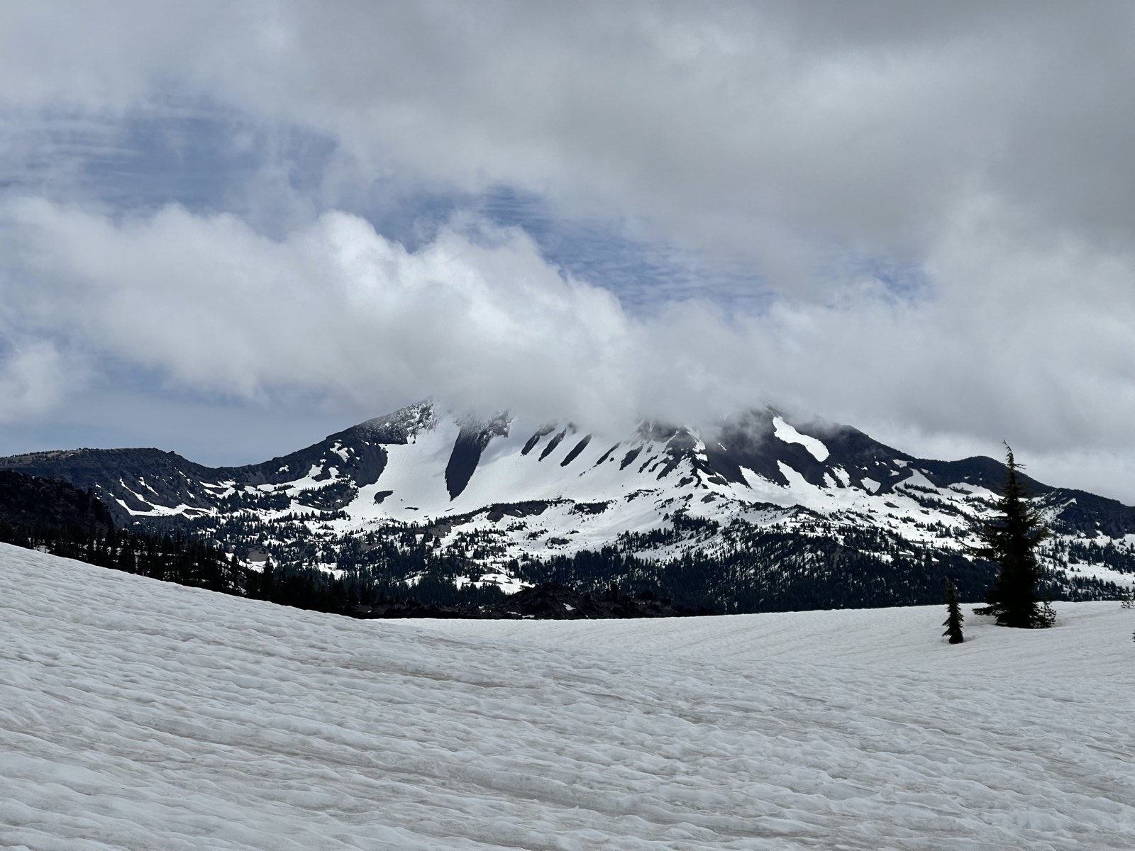 The jagged outline of Broken Top across the snowfield