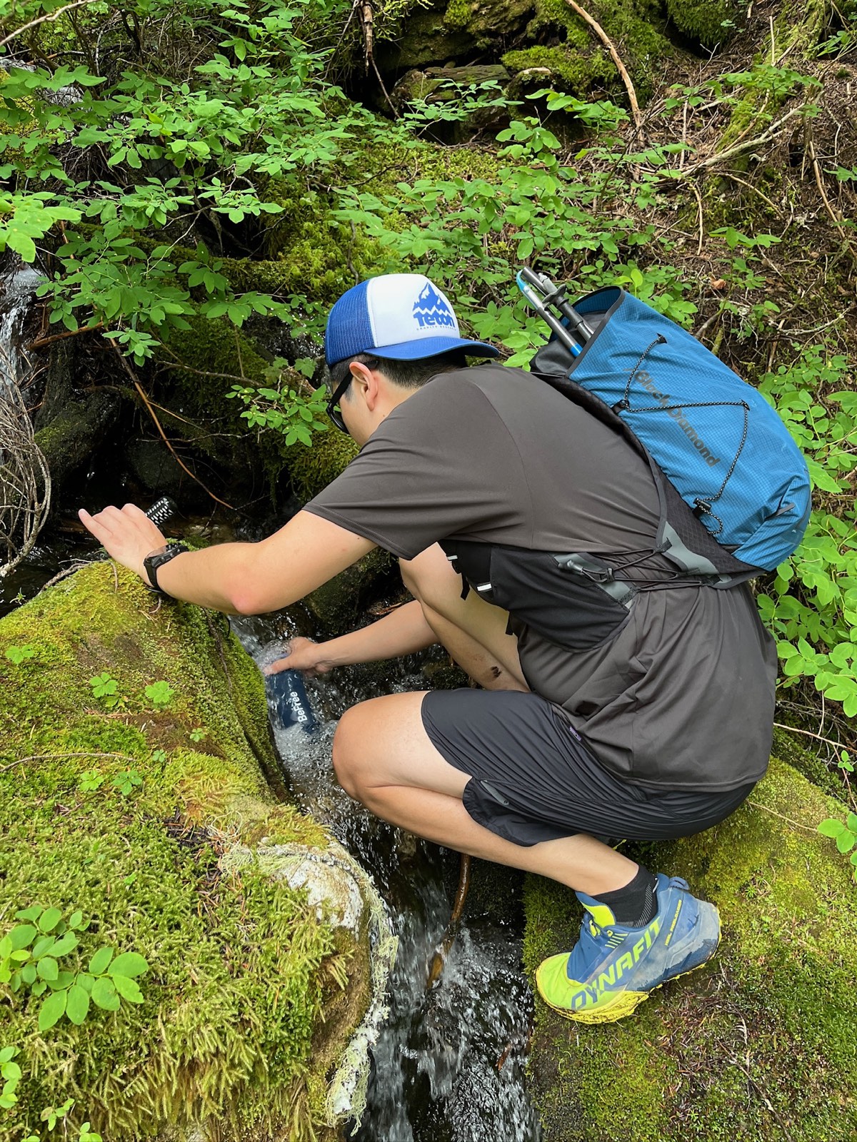 Filtering cold meltwater into a bottle partway up the climb