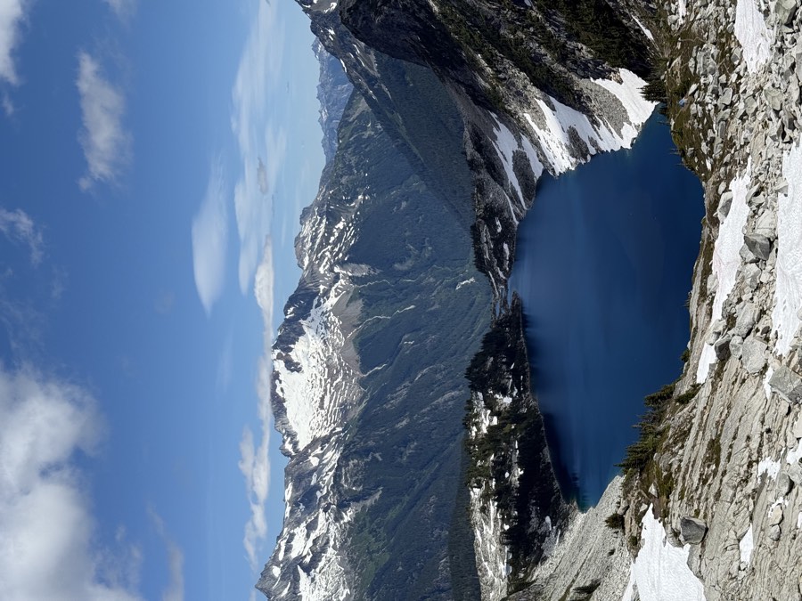 Hidden Lake coming into view in the basin below the trail