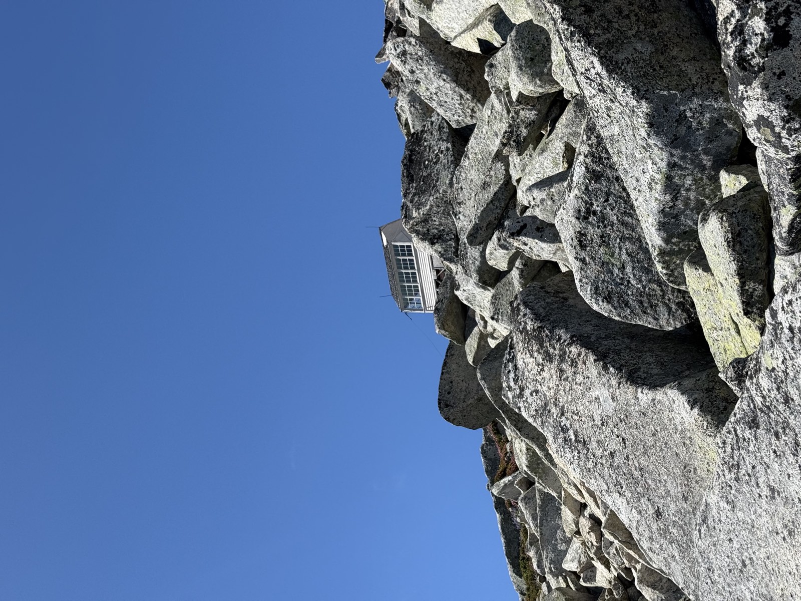 The small wooden lookout cabin standing on bare rock