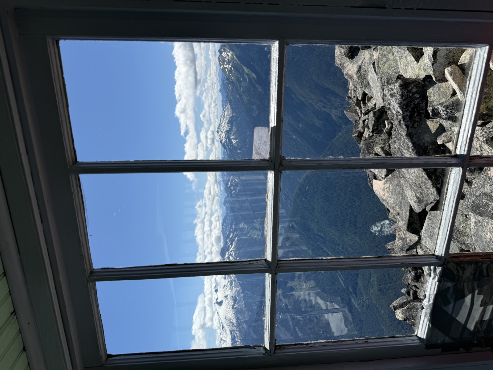 Mountains framed by the windows of the lookout cabin