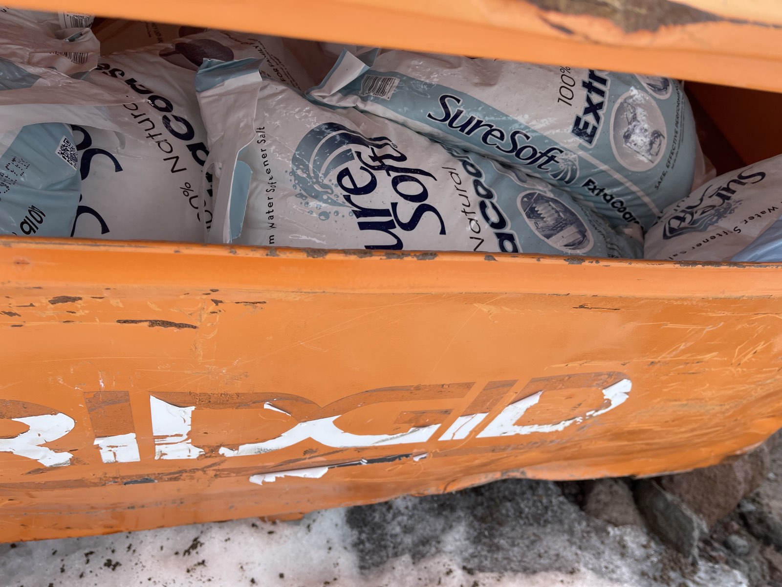 A container of rock salt left on the snow