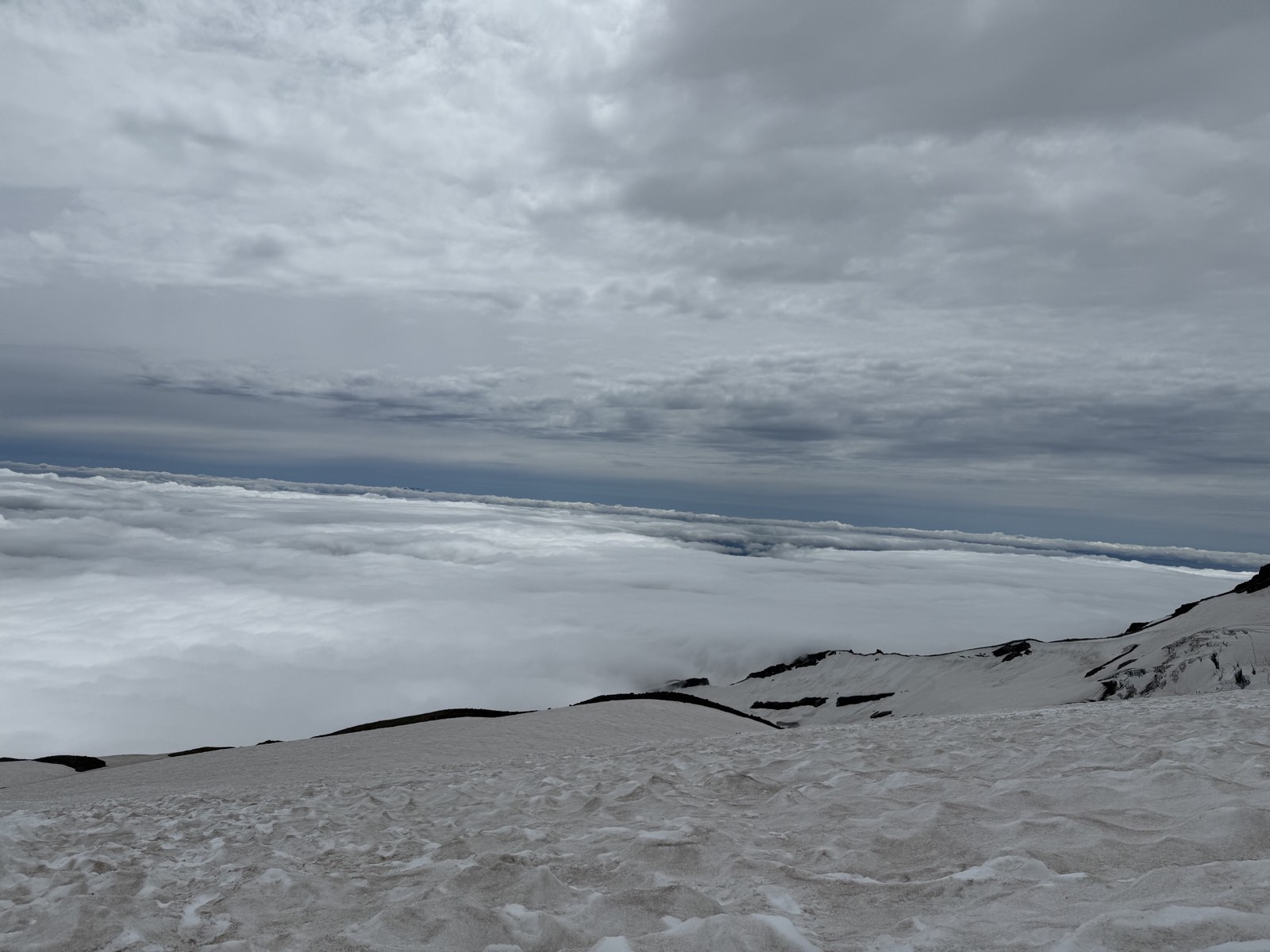 A flat blanket of cloud spread out below the climb