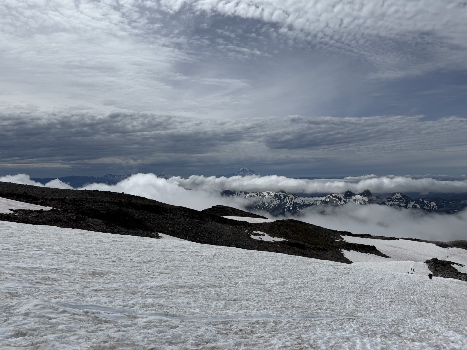The wide snow slope of the Muir Snowfield ahead on the route
