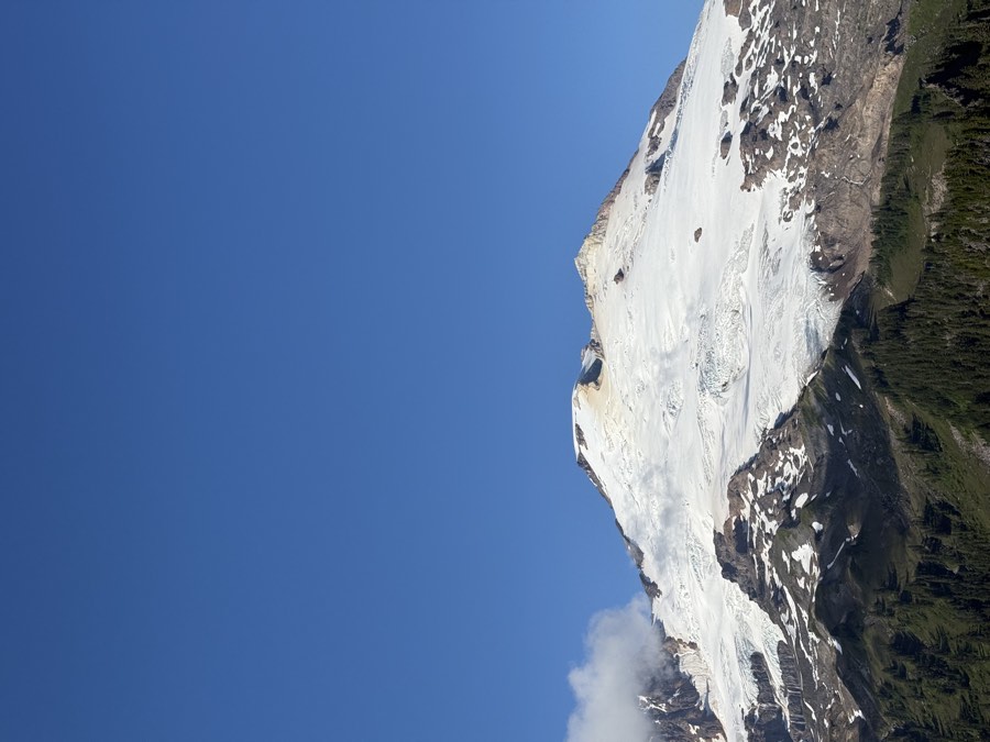 The snow-covered summit of Mount Baker against a clear blue sky