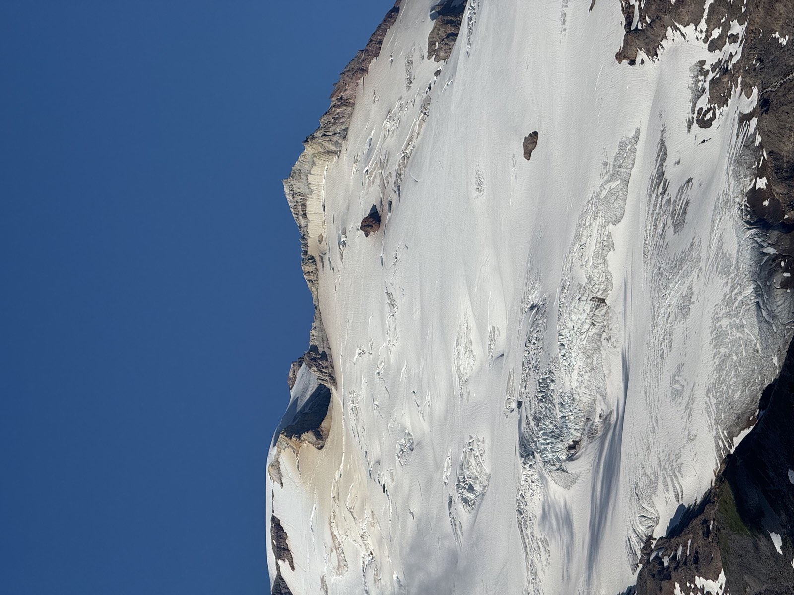 Wide glacial slopes seamed with crevasses below the summit of Mount Baker
