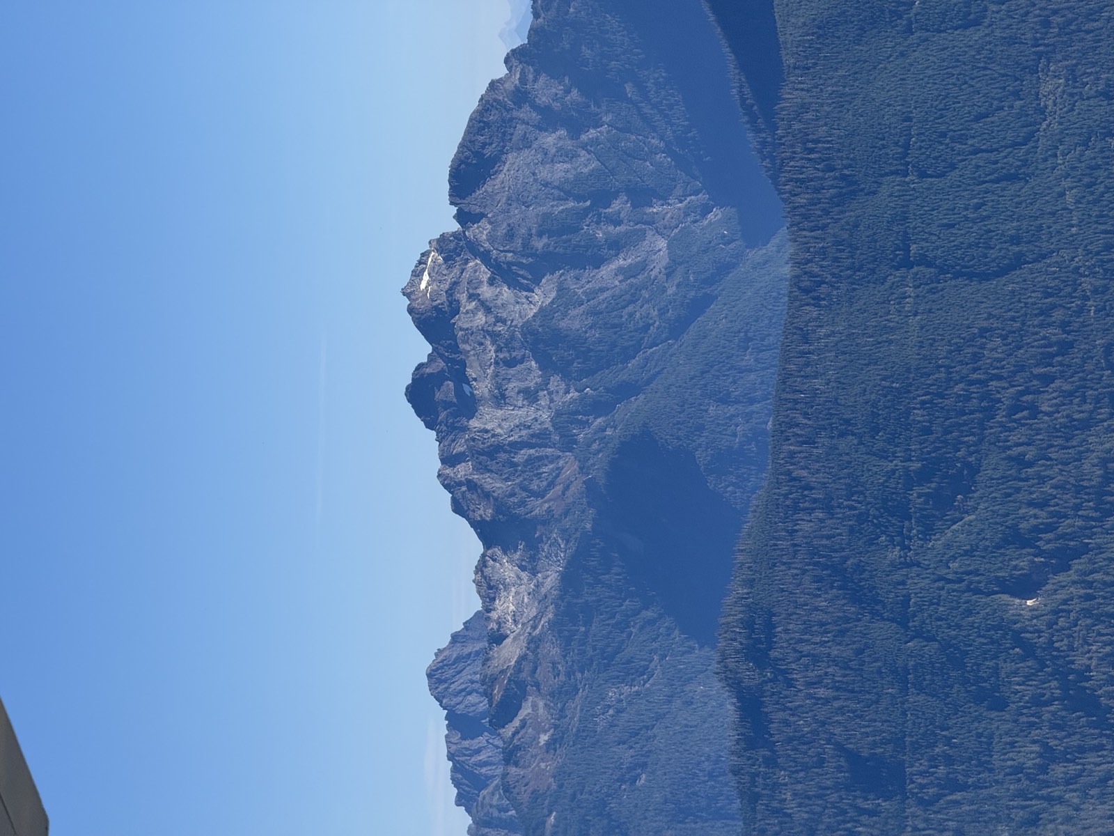 A close view of a craggy granite massif, with the edge of the lookout roof in the corner