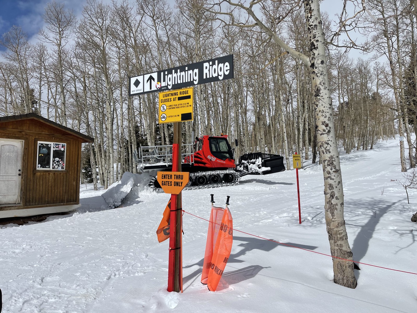 A snowcat waiting on the snow to shuttle skiers uphill