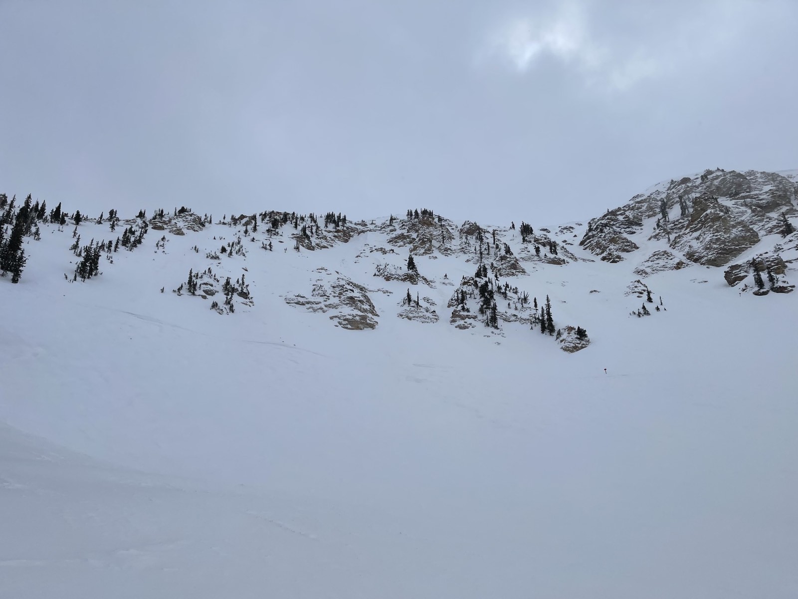 Low clouds moving in over a steep chute