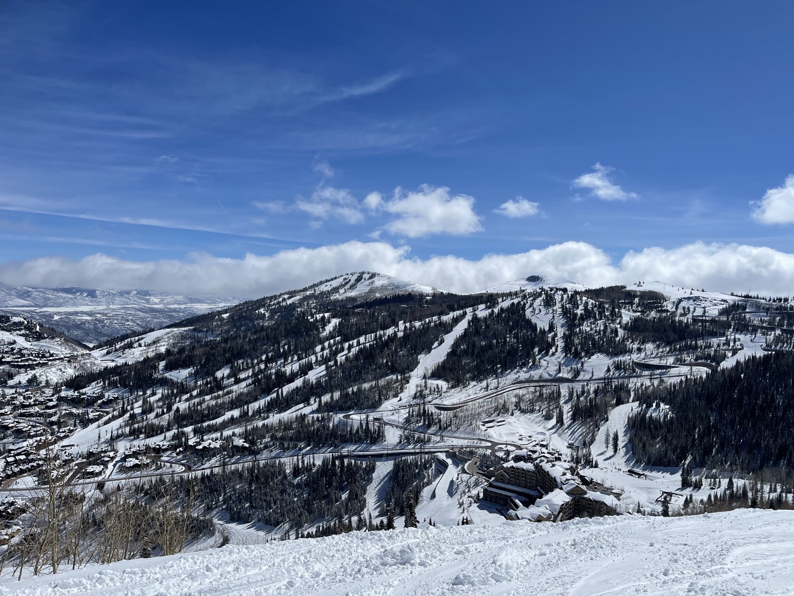 Condominium buildings and a road running between ski runs at Deer Valley