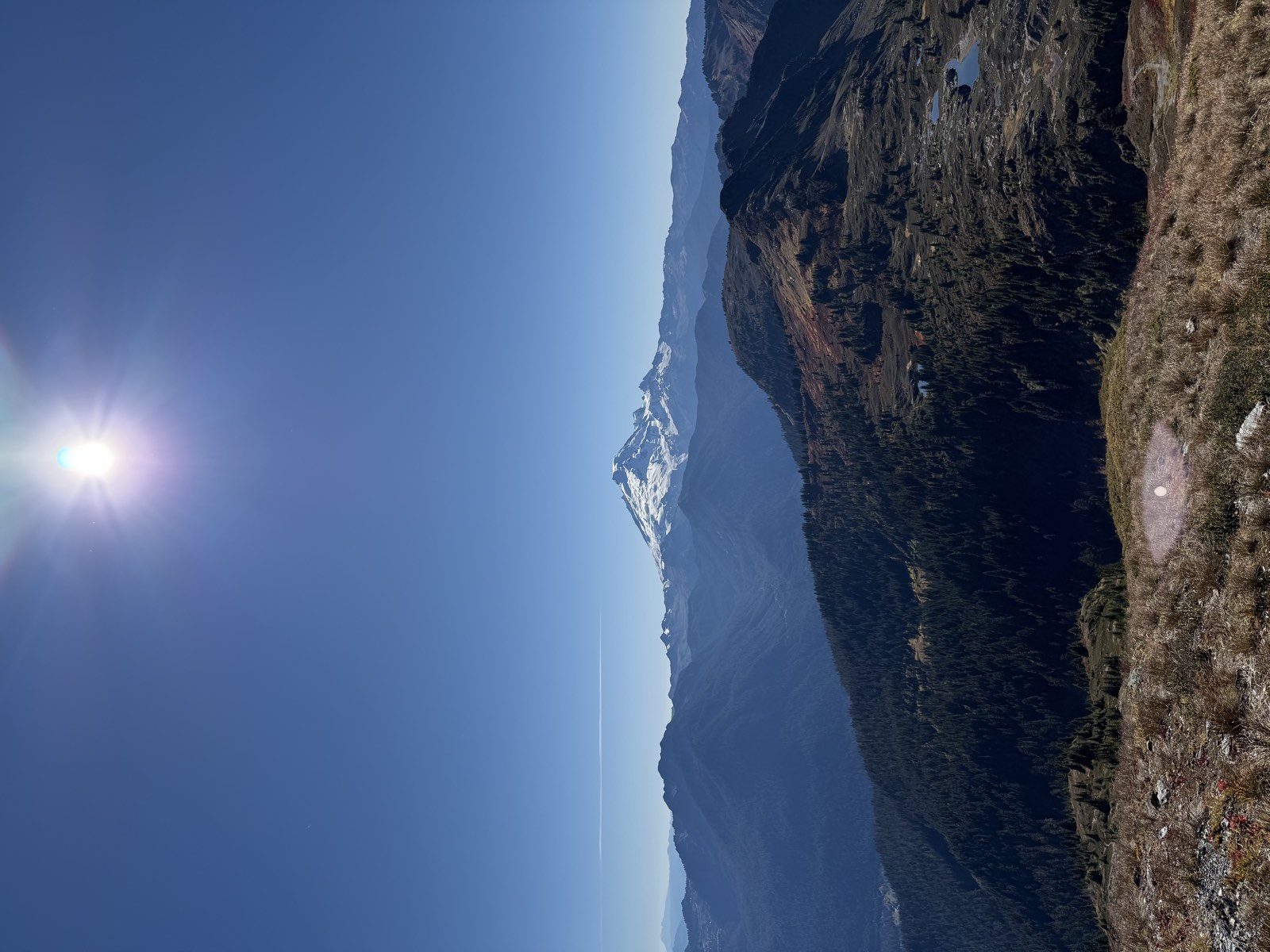 Mount Baker on the horizon above forested ridges and small tarns far below